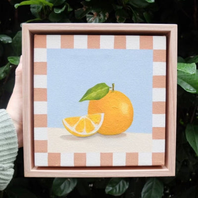 framed painting of an orange